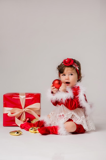 baby Santa with gift box on white