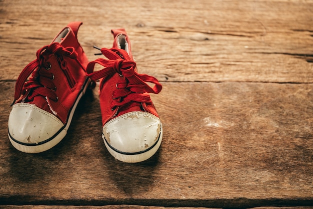 Baby shoes on wooden background