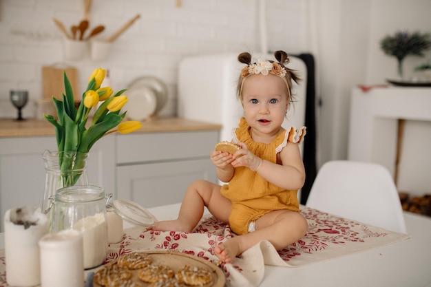 Baby sits on a table in a scandinavian kitchen