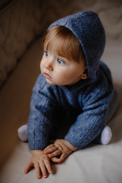 Baby sitting in his bed very beautiful baby with blue eyes