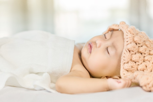 Baby sleeping on bed in the bedroom