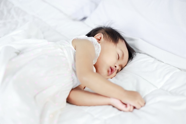 baby sleeping on bed at home