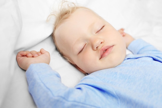 Baby sleeping on bed