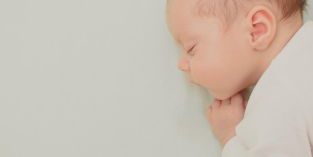 The baby sleeps in the copy space crib Advertising of children's goods Illustrating children's articles A small child A newborn