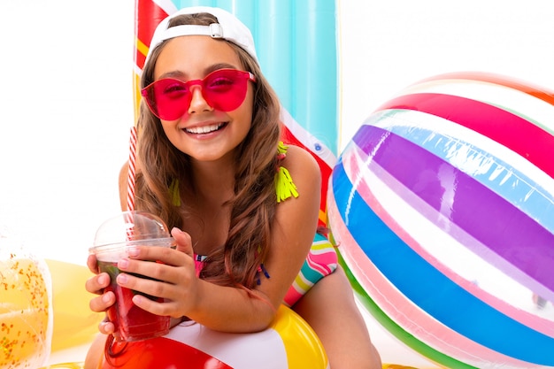 Baby in a swimsuit with a wide smile on his face, summer vacation concept, isolated white background