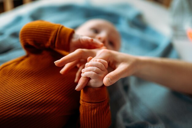 Baby toddler holding mother's hand Holding hand of newborn child