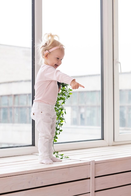 Baby with cochlear implants at home deafness and medical technology concept