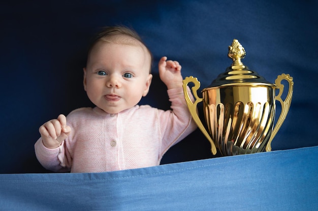 Baby with golden cup victory