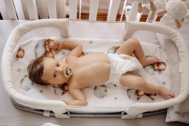 Baby with pacifier baby portrait in his crib