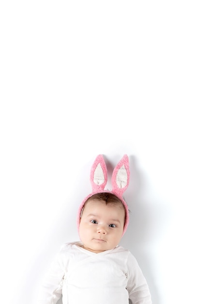 Baby with rabbit ears on a white background Concept blank for Easter Mockup for advertising design celebration postcards Copy space