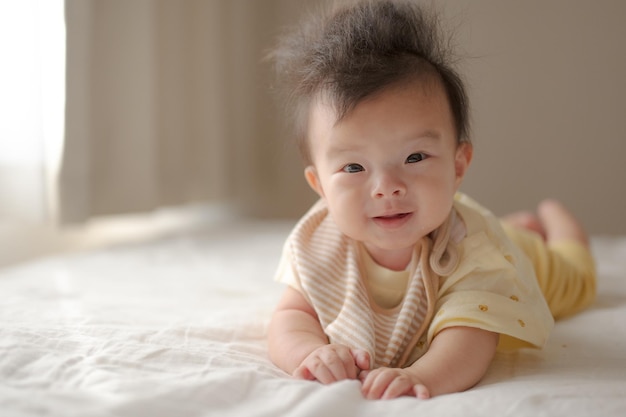 A baby with a yellow shirt that says'baby '