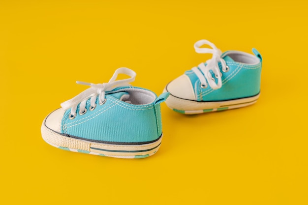 Babys little sneakers on a colorful background concept of traveling with baby kids lifestyle