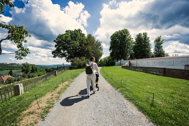 Back of father with baby carriage walking at Chateau Kunstat Czech Republic