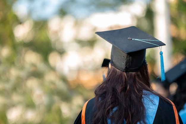 The back of the graduates are walking to attend the graduation ceremony at the university	