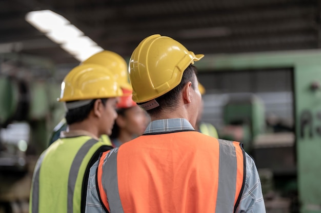 Back of head engineers meeting factory worker people walk and check in warehouse factory