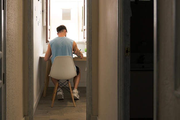 Back of a man working and studying at home