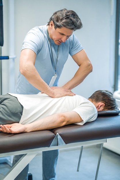 Back massage Male patient having a session of rehabilitation back massage