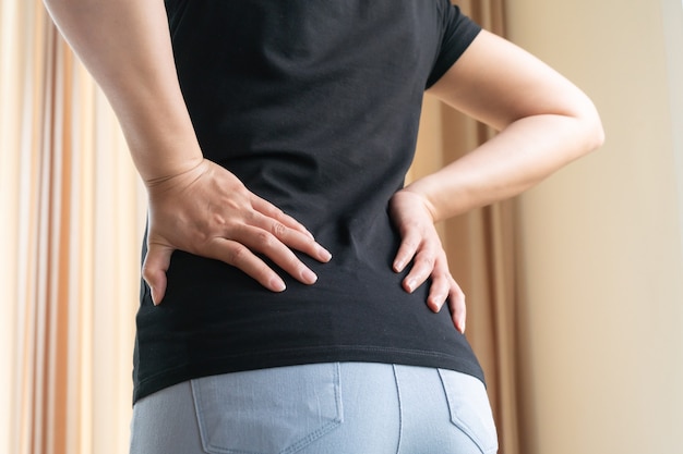 Back pain at home. women suffer from backache. healthcare and medical concept