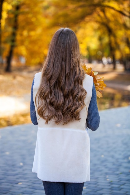 Back rear view brunette hair model autumn park outdoor