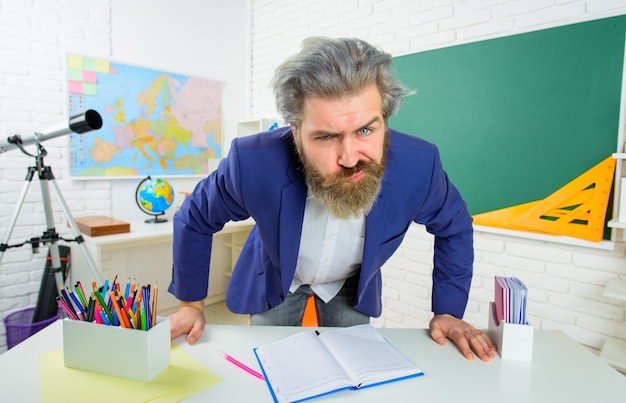 Back to school angry teacher learning education school concept serious teacher in suit teacher man