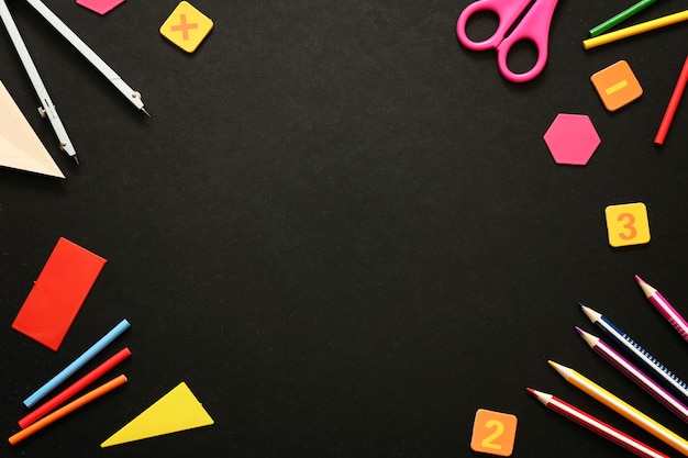 Back to school background: school supplies on black chalk board