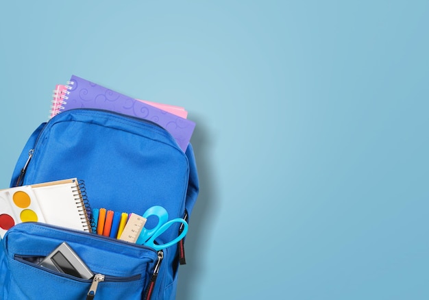 Back to school concept. Backpack with school supplies. Top view. Copy space