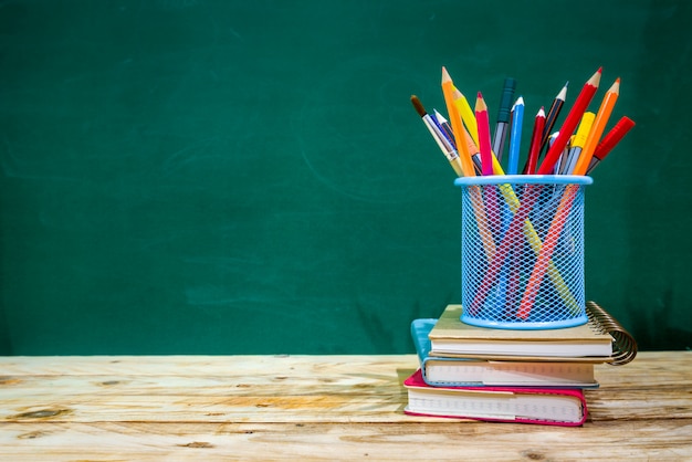 Back to school concept. colored pencil, and supplies  on wooden table