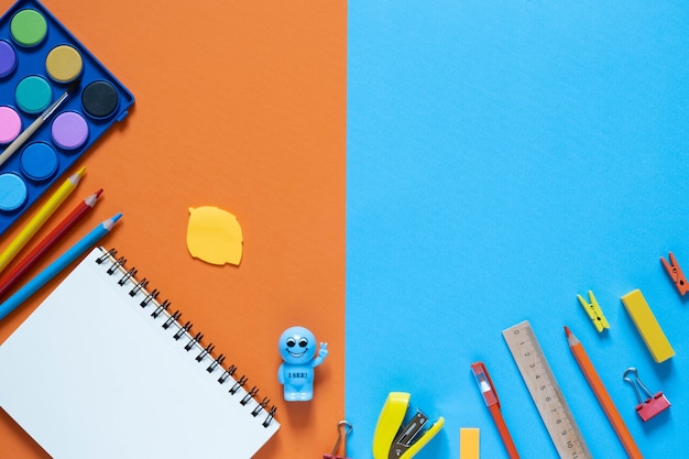 Back to school concept. School and office supplies on the office table. 2 color background.Flat lay with copy space.Autumn