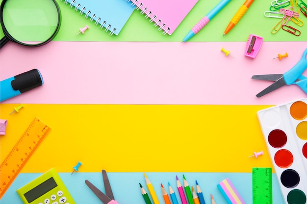 Back To School concept. School supplies on colorful background with copy space