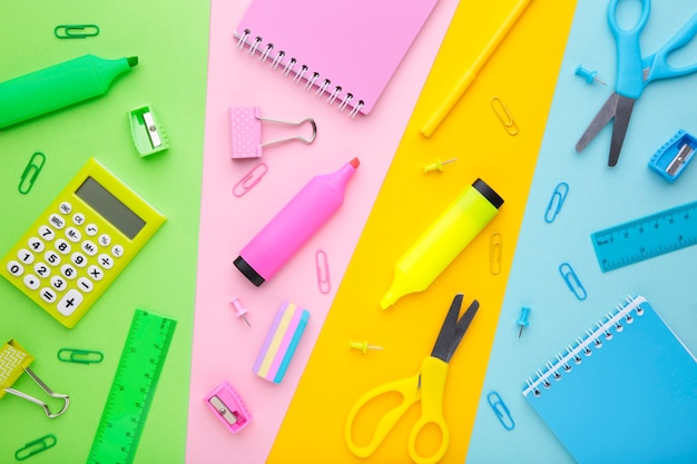 Back To School concept. School supplies on colorful background