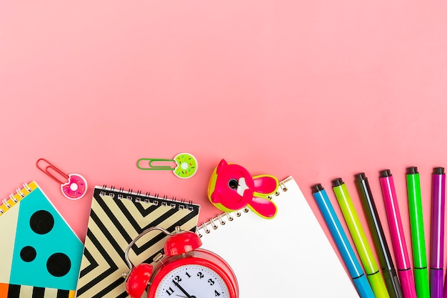 Back to school concept. School supplies on pink, flat lay. 