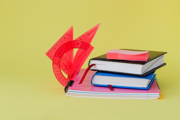 Back to school concept with space for text Copy space School office suppliesCreative desk with colourful stationery Colored paper clipSchool supplies on yellow backgroundOffice desk