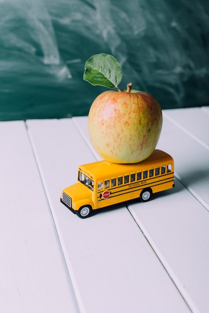 Back to school concept with toy schoolbus