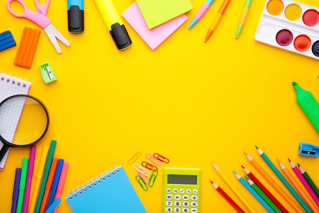 Back to school concept on yellow background with copy space