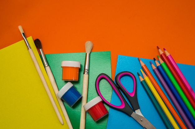 Back to school. Items for the school on a orange table. High quality photo