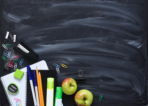 Back to school School supplies on the blackboard Layout of school accessoriesDistance learning