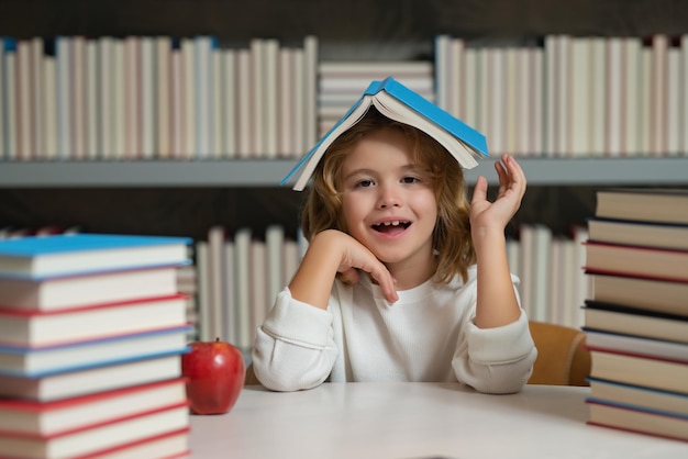 Back to school Schoolboy reading book in library Kids development learn to read Pupil reading books in a school library School child doing homework study hard