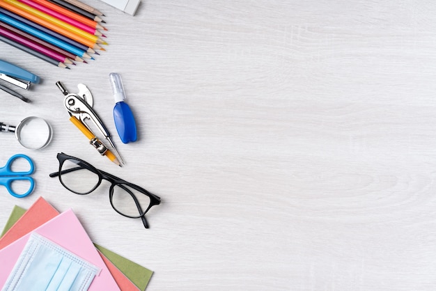 Back to school student design concept, top view of stationery over wooden table background with copy space.