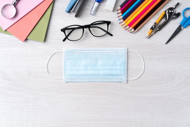 Back to school student design concept, top view of stationery over wooden table background with copy space.