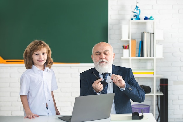 Back to school teacher and child education and learning concept schoolboy in classroom old teacher a