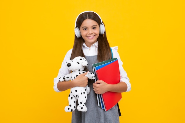 Back to school Teenager schoolgirl hold toy School children with favorite toys on isolated yellow