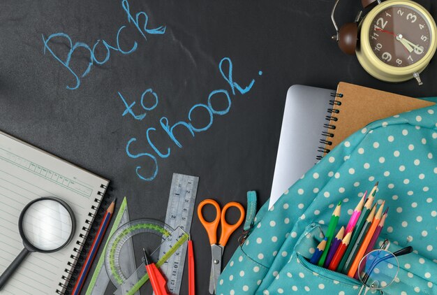 Back to school text with backpack and school supplies