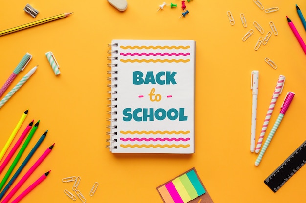 Back to school with a notebook with lettering and several stationery objects