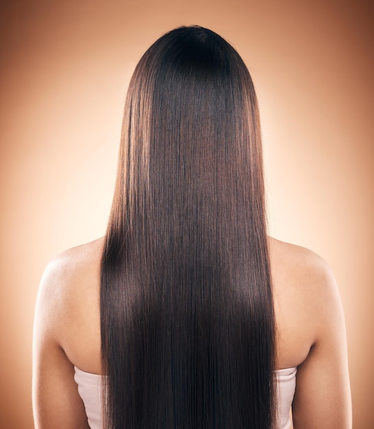 Back straight hair and beauty of woman in studio isolated on a brown background Haircare natural cosmetics and model with salon treatment for balayage hairstyle growth and aesthetic for wellness