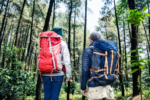 Back view of asian backpacker couple traveling together