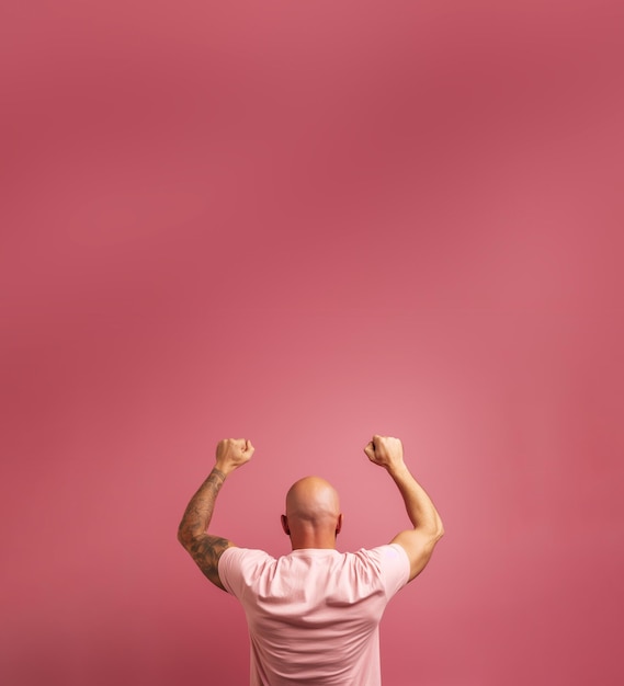 Back view of a man over a pink background