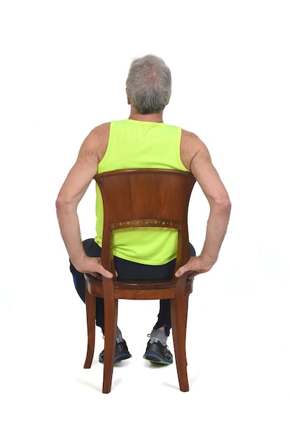 Back view of a man sitting on chair with sportswear on white background