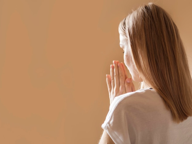 Back view of woman praying