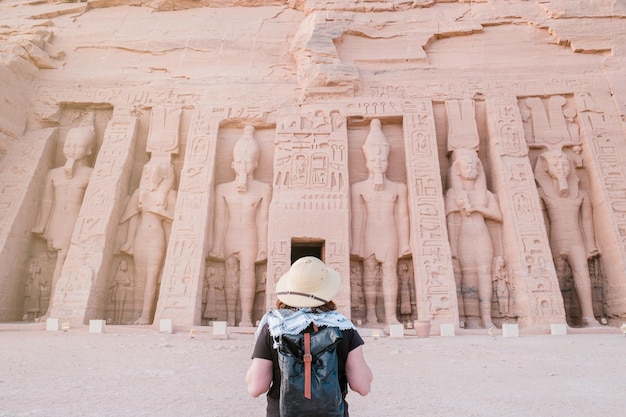 back view of woman standing in front of Abu Simbel temple in Aswan Egypt