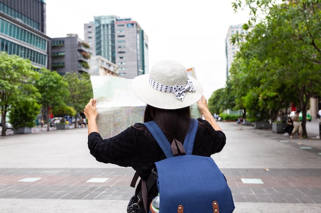 Back view Woman tourist with maptravel in Vietnam